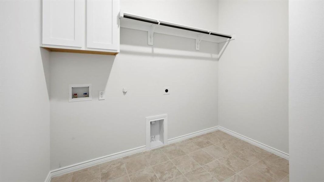 Laundry room with gas dryer hookup, electric dryer hookup, washer hookup, and cabinet space