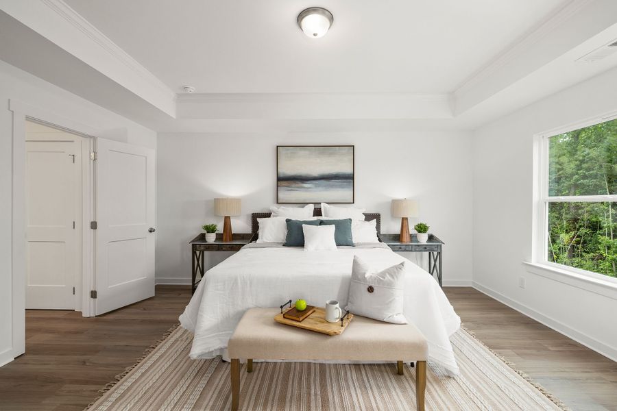 Oversized primary bedroom with large windows