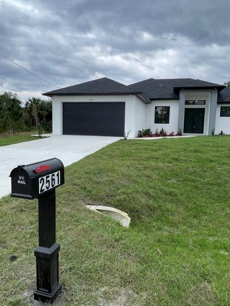 Front exterior of a new home in , Lehigh Acres, FL, highlighting curb appeal (Image 18). Front exterior of a new home in , Lehigh Acres, FL, highlighting curb appeal (Image 18).