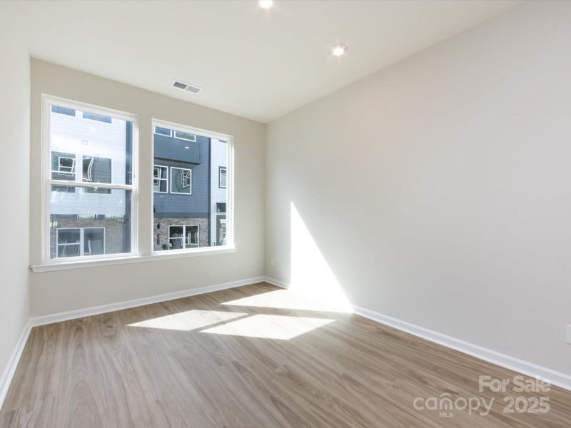 Dining Space Bathed in Light From Large Windows.