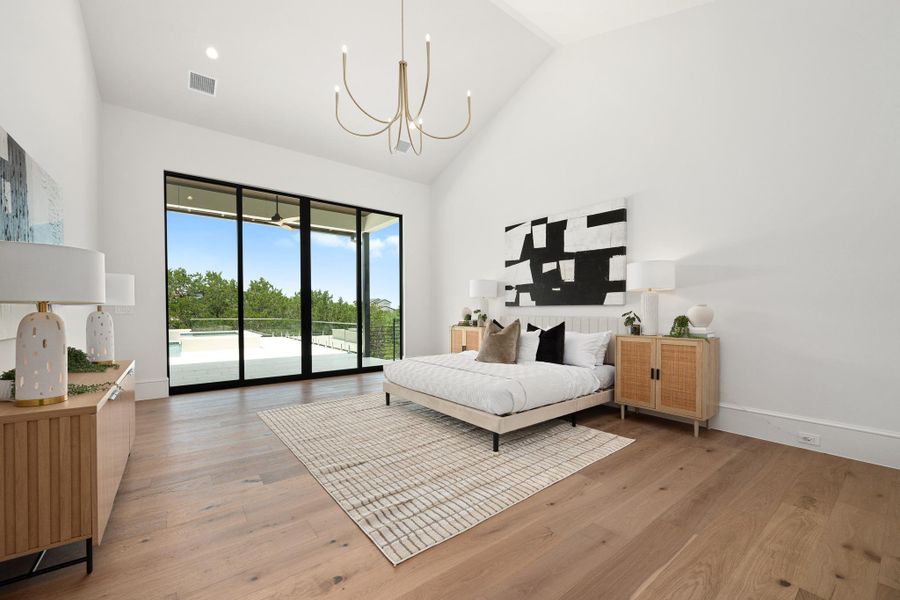 Natural light floods this room, highlighting the beautiful wood flooring and vaulted ceilings.