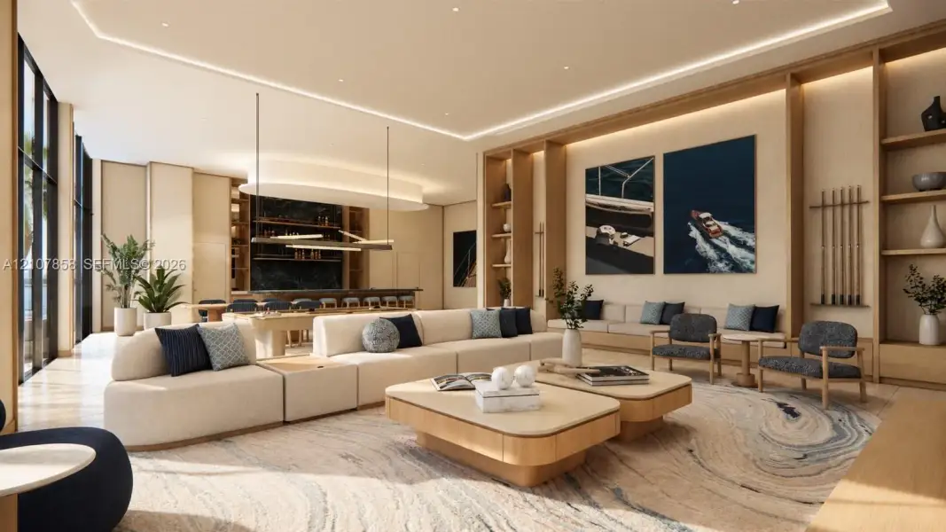 Open-concept room featuring integrated wood shelving, recessed cove lighting, floor-to-ceiling windows, and a built-in wet bar with dark stone surfacing Open-concept room featuring integrated wood shelving, recessed cove lighting, floor-to-ceiling windows, and a built-in wet bar with dark stone surfacing