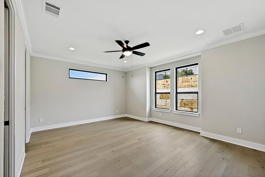 Hardwood floors and a ceiling fan complete this airy, south facing room. There is an en-suite and very large walk-in closet