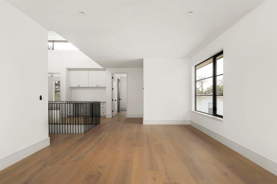 Unfurnished living room with light wood finished floors and healthy amount of natural light