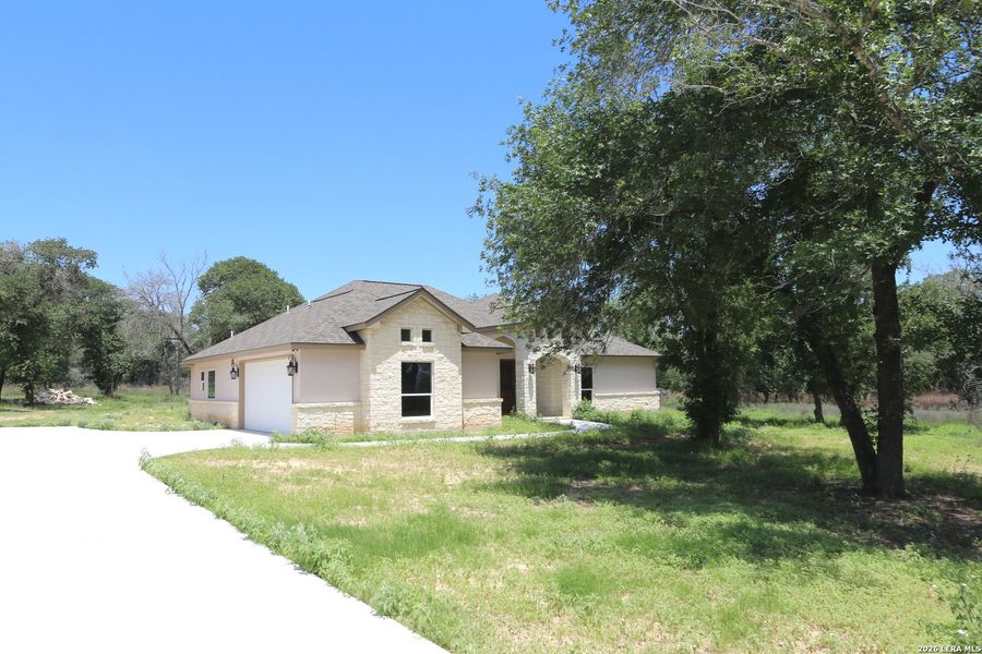 Front exterior of a new home in , Floresville, TX, highlighting curb appeal (Image 27).