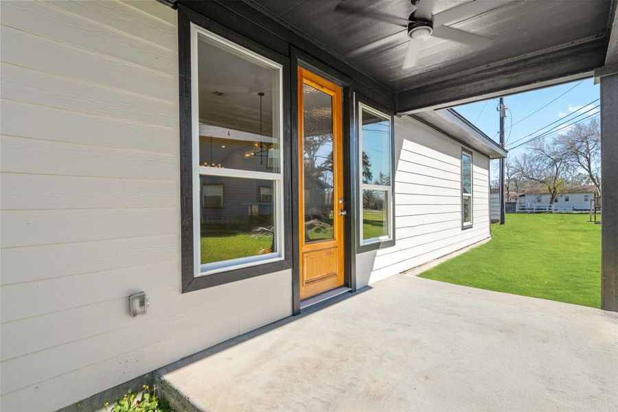 Inviting covered patio just off the home, perfect for morning coffee or evening gatherings, blending indoor comfort with outdoor charm.