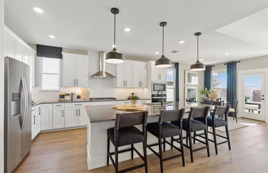 *Model Representation - Large island overlooking gathering room and dining areas