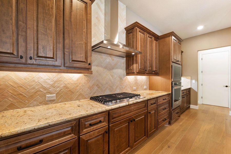 Culinary delights await in this chef's kitchen featuring high-end appliances and ample counter space. Culinary delights await in this chef's kitchen featuring high-end appliances and ample counter space.