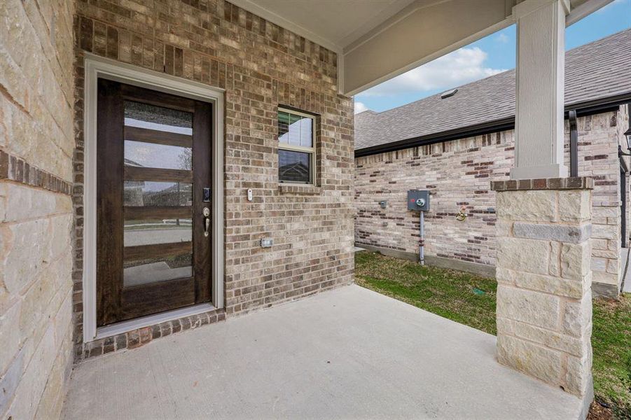 Exterior details and patio area of a home in Parks at Foster Crossing - Spring Series, Anna (Image 3).