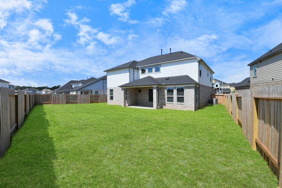 Explore the expansive backyard with its inviting covered patio—a perfect blend of space for the kids to play and adults to unwind. Ideal for creating your outdoor oasis, this backyard accommodates patio furniture, a BBQ pit, and endless possibilities for leisure and entertainment. Sample photo of completed home with similar floor plan. Actual colors and selections may vary.