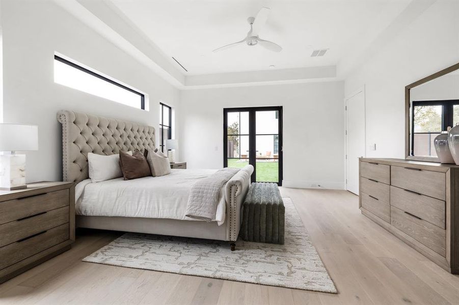 Bedroom featuring access to exterior, french doors, visible vents, and light wood-style flooring