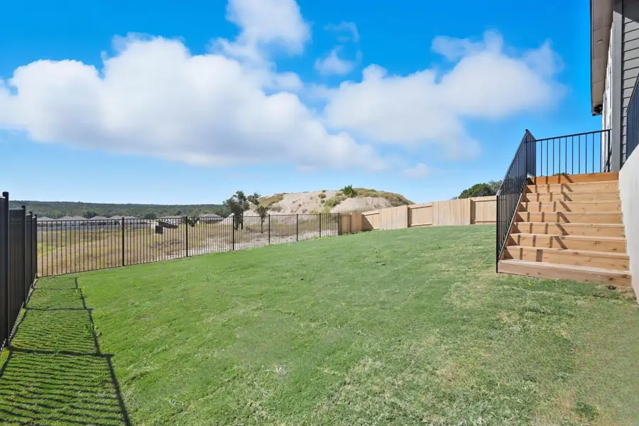 Fenced backyard featuring stairway