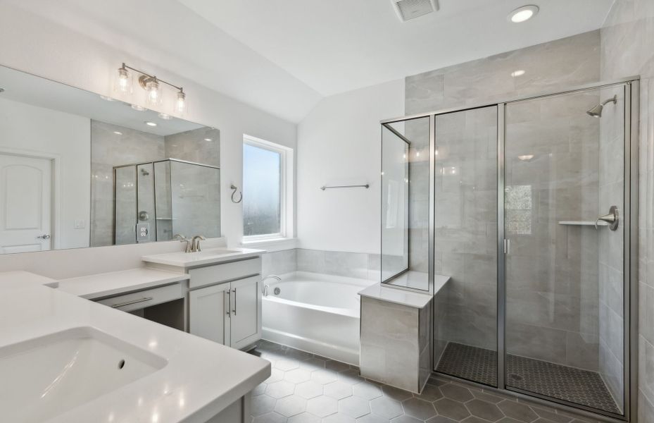 Owner's bath with separate vanities