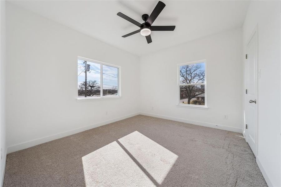 2nd bedroom (2nd floor) with ceiling fan and light carpet