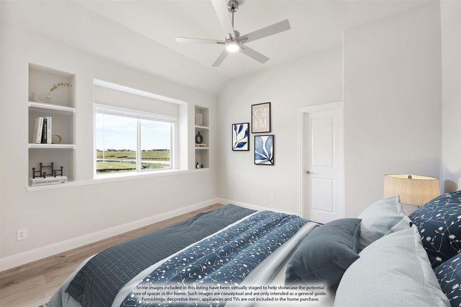 Bedroom with vaulted ceiling, ceiling fan, built-in shelves, and large window with outdoor view