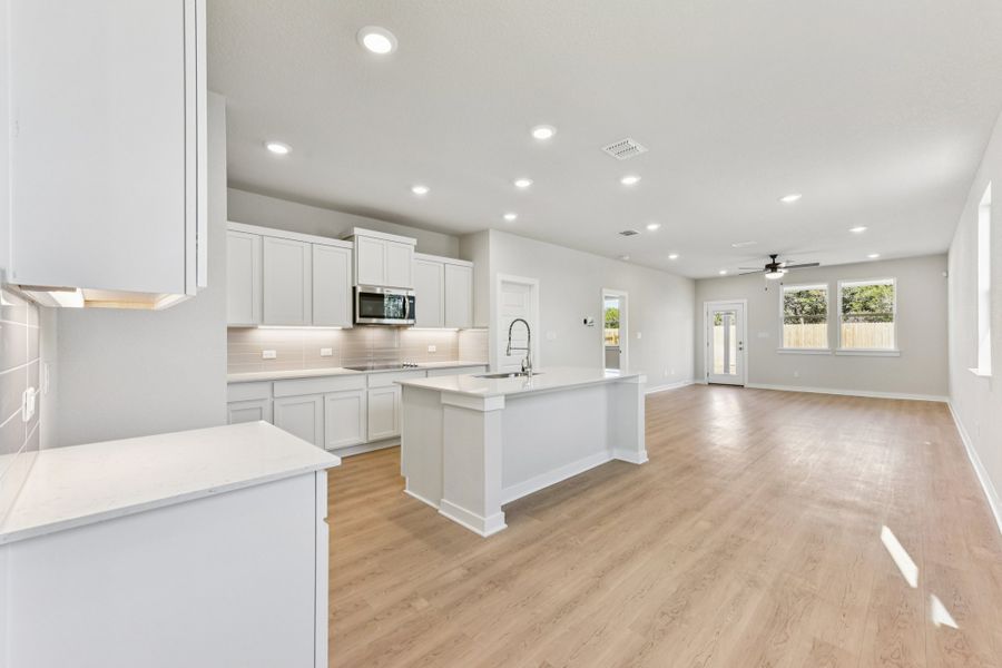 A kitchen with white cabinets.