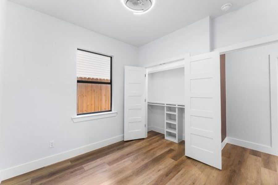 Unfurnished bedroom with light wood-type flooring and a closet Unfurnished bedroom with light wood-type flooring and a closet