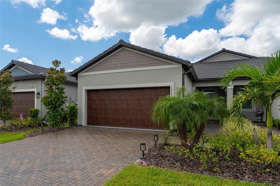 Front exterior of a new home in Prosperity Lakes Active Adult, Parrish, FL, highlighting curb appeal (Image 24).