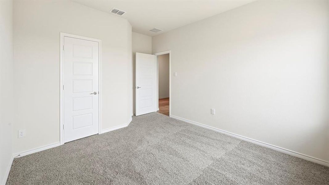 Unfurnished bedroom featuring carpet and baseboards