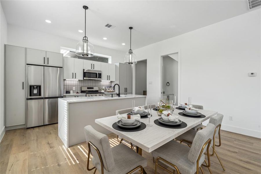 Another view of the dining area that gives way to the main attraction on the first floor the stunning kitchen with pantry located to the right.