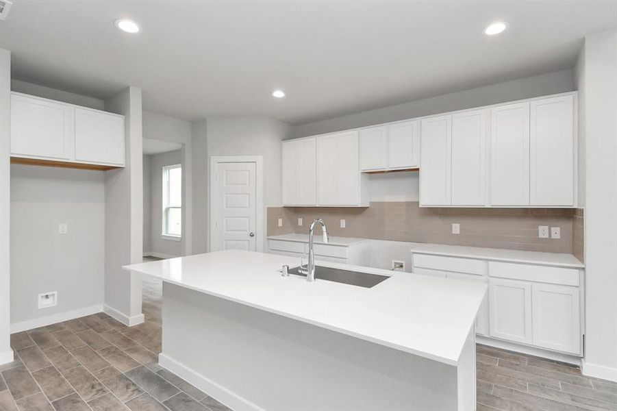 Revel in features in this kitchen like a massive granite island, high ceilings, soft-close cabinets, quartz countertops. Sample photo, actual color and selections can vary.