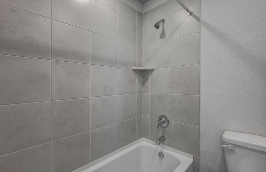 A bathroom with a bathtub and toilet. A bathroom with a bathtub and toilet.