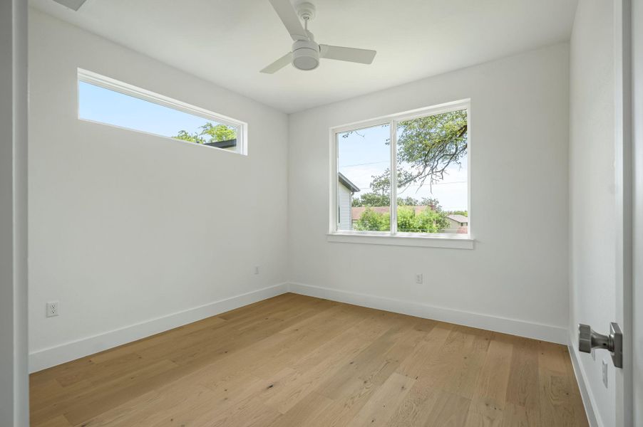 Blonde hardwood flooring and generous windows define this peaceful, naturally illuminated room. Blonde hardwood flooring and generous windows define this peaceful, naturally illuminated room.