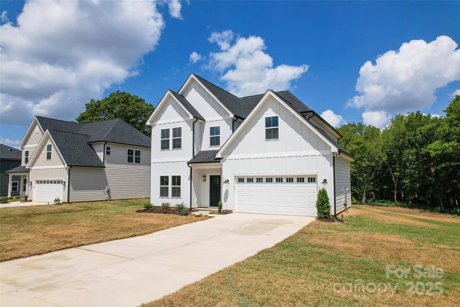 Front exterior of a new home in , Harrisburg, NC, highlighting curb appeal (Image 20).