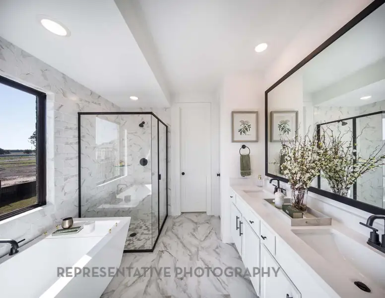 Bathroom featuring a soaking tub, a marble finish shower, double vanity, marble finish floors, and recessed lighting