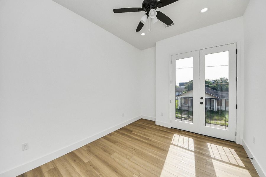 Bright guest bedroom with abundant natural light and a clean, modern feel.