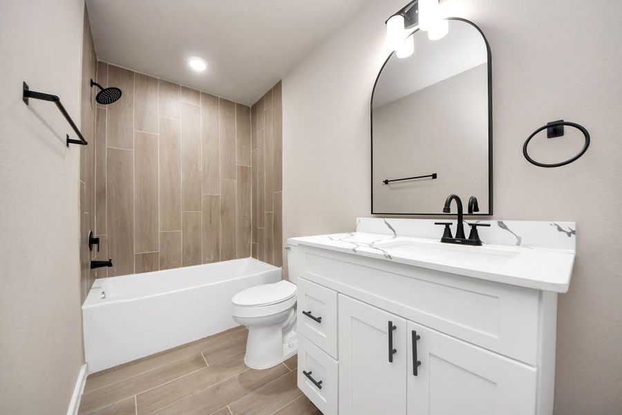 A modern, two-story home with a spacious driveway and a two-car garage. The exterior features a mix of light siding and dark accents, complemented by a neatly landscaped front path. Offering a serene and inviting atmosphere. A modern, two-story home with a spacious driveway and a two-car garage. The exterior features a mix of light siding and dark accents, complemented by a neatly landscaped front path. Offering a serene and inviting atmosphere.