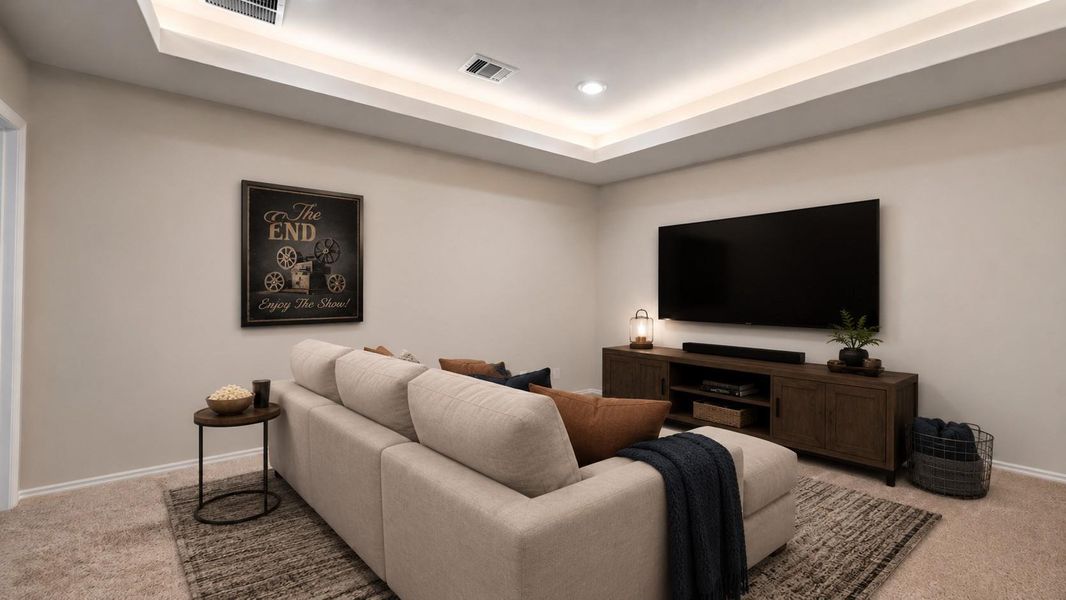 This space for media room includes a tray ceiling with recessed accent lighting and neutral carpeted flooring.**This room has been virtually staged.