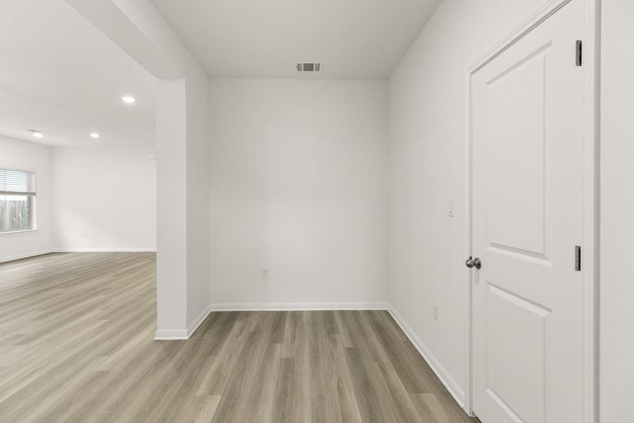 The property features light-toned flooring, white walls, and a white door with a round dark doorknob