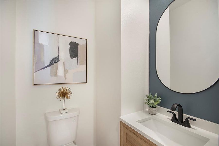 Half bathroom with vanity and toilet Half bathroom with vanity and toilet