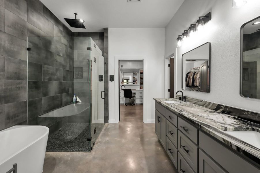 Ensuite bathroom includes double vanity with stylish features, and ample lighting.
