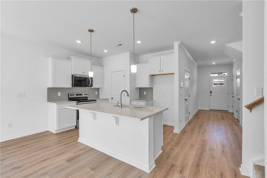 This bright kitchen features an island, ample coun