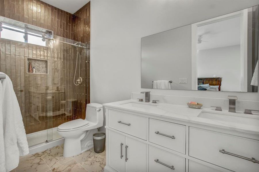 Ensuite bathroom with double vanity and a shower stall