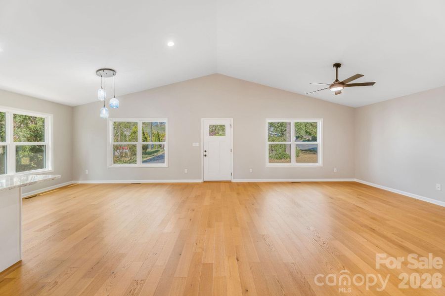 beautiful living and dining space with custom pendants