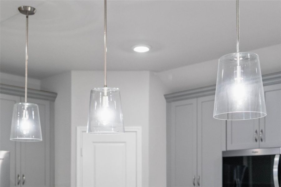Clarion Pendant Brushed Nickel lights that hang over the kitchen counter.