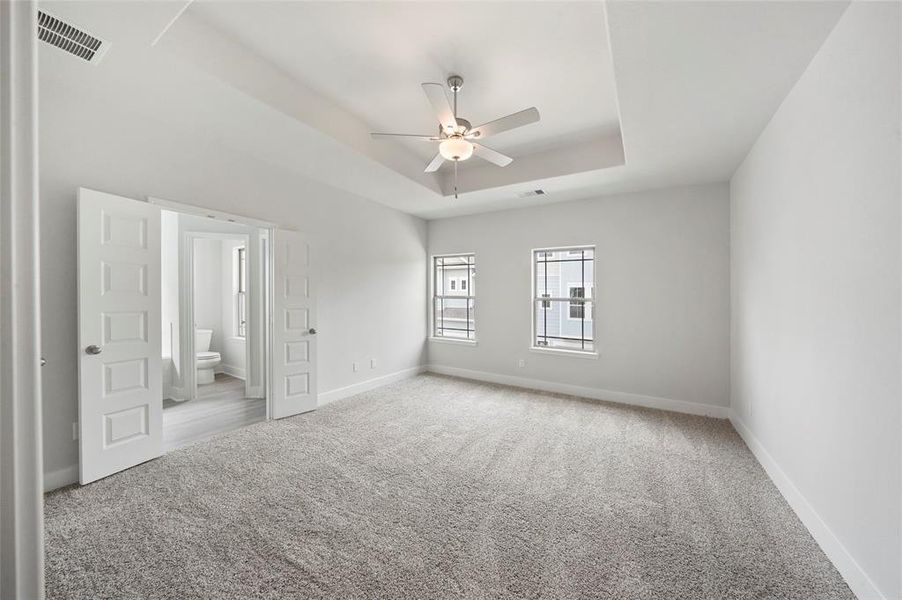 Primary bedroom with high ceilings