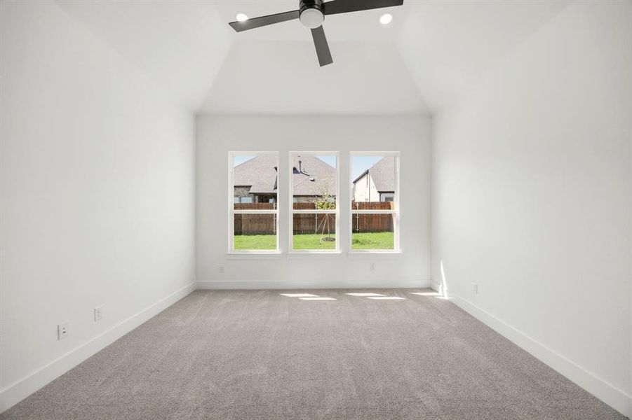 Spare room with carpet, ceiling fan, lofted ceiling, and recessed lighting