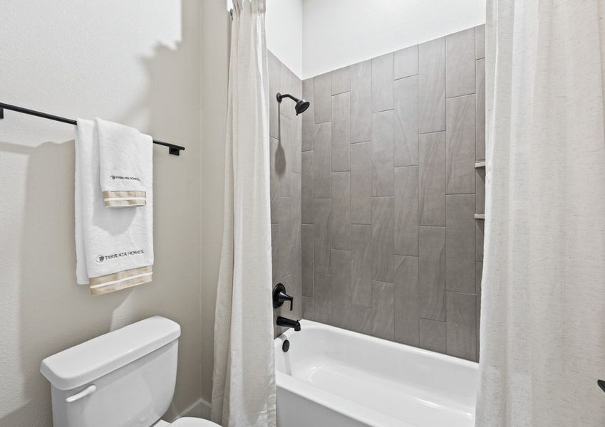 The secondary bathroom has a shower-tub combo.