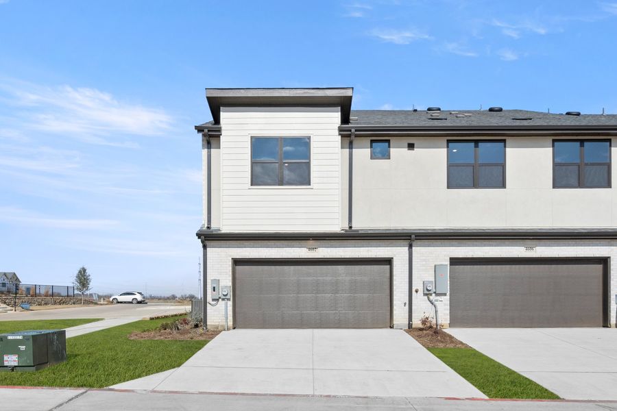 Front exterior of a new home in Wildridge, Oak Point, TX, highlighting curb appeal (Image 20).