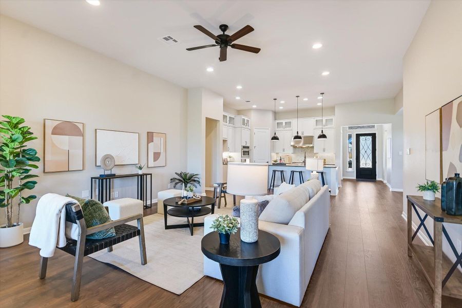 The open concept living-kitchen-dining room features tall ceilings and a fantastic greenbelt view!