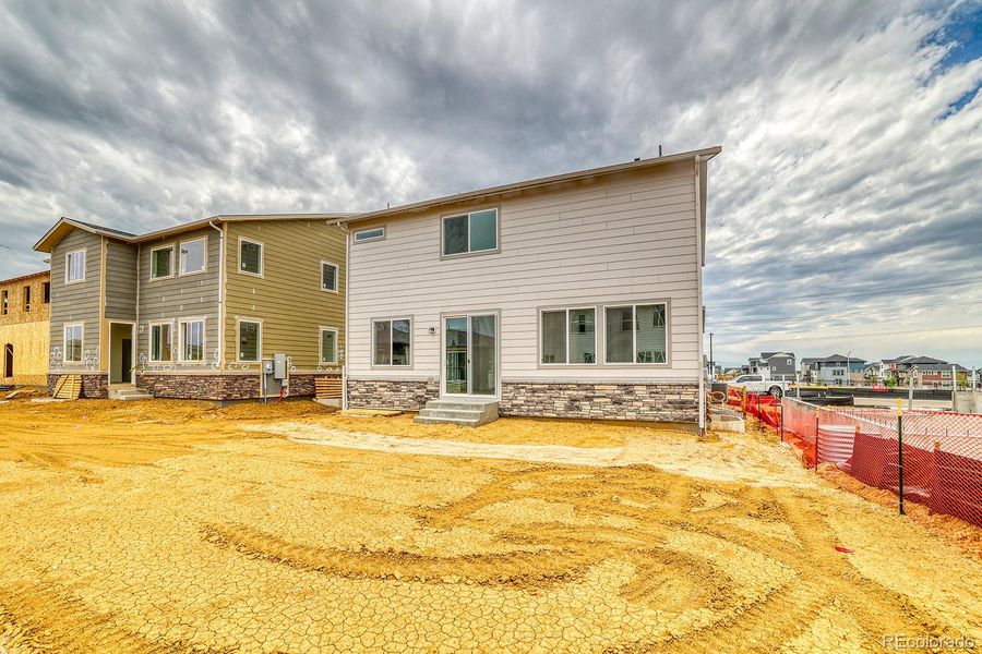 Front exterior of a new home in Harvest Crossing, Aurora, CO, highlighting curb appeal (Image 13). Front exterior of a new home in Harvest Crossing, Aurora, CO, highlighting curb appeal (Image 13).