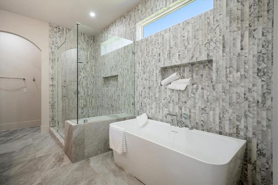 Primary bath, freestanding soaking tub, Calacatta Giallo tile surround, shower niche, clerestory window Primary bath, freestanding soaking tub, Calacatta Giallo tile surround, shower niche, clerestory window