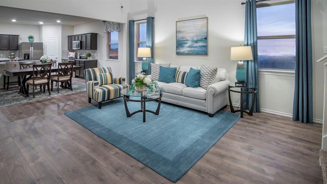 Living room with dark wood finished floors and recessed lighting
