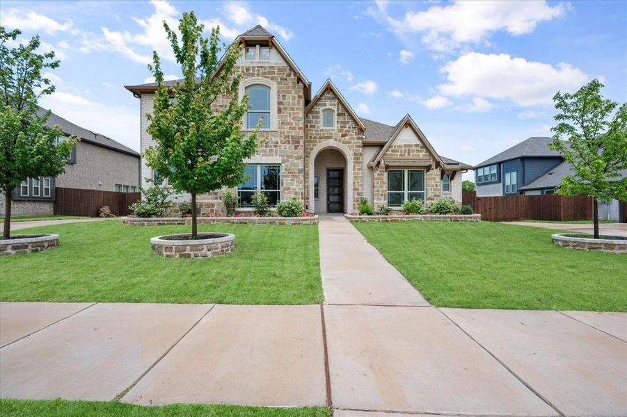 Front exterior of a new home in Wind Ridge, Midlothian, TX, highlighting curb appeal (Image 2). Front exterior of a new home in Wind Ridge, Midlothian, TX, highlighting curb appeal (Image 2).