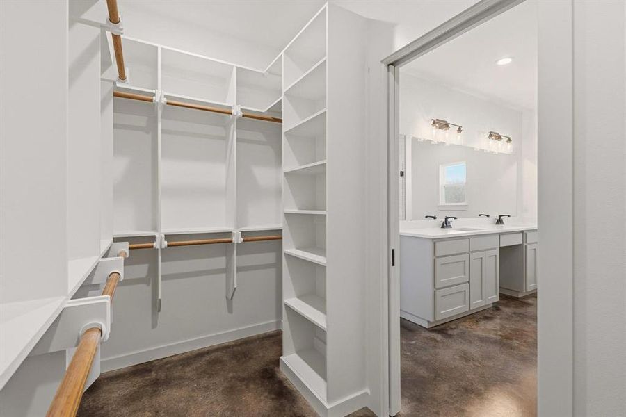 The property features a spacious walk-in closet with extensive built-in shelving and hanging rods