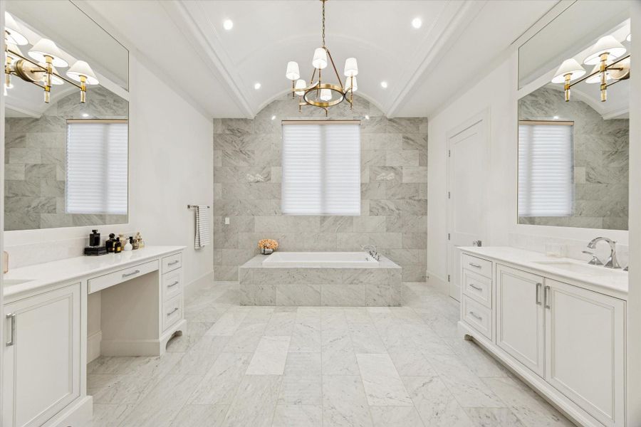 Primary bath with barrel ceiling, marble accents and dual vanity areas Primary bath with barrel ceiling, marble accents and dual vanity areas